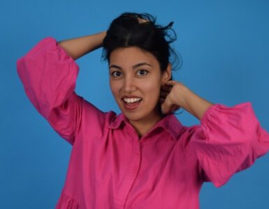 Woman in pink top holding up her hair